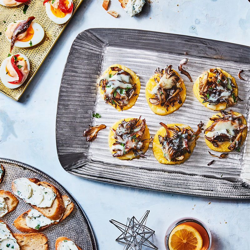  Store-bought tubes of polenta are the ultimate appetizer shortcut: just slice and toast in the oven, top with sautéed wild mushrooms and a sprinkle of grated Fontina, then bake again until melty and irresistible. 